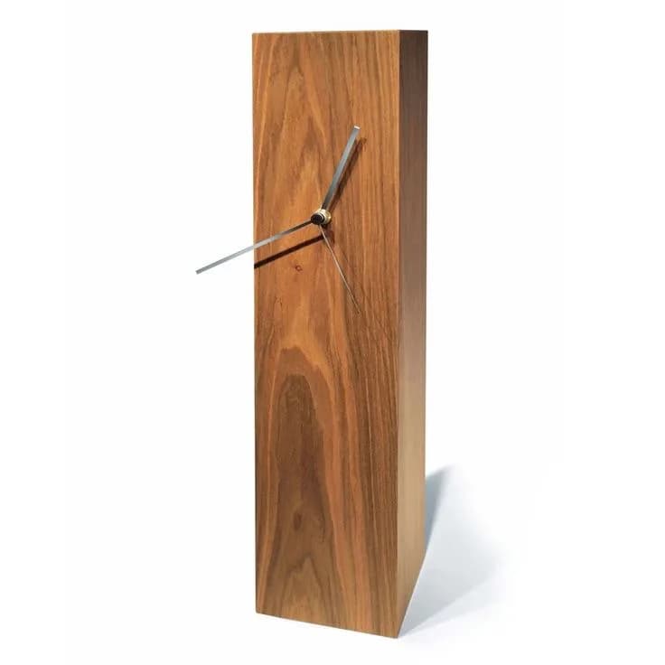 Solid walnut block desk clock with bare metal hands, photographed on a white studio background.